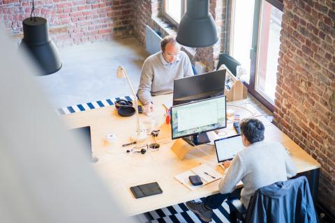 Photo of two men sitting at a desk