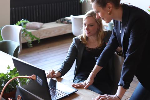 Image of two women looking at a laptop